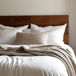 **

Prompt: "A perfectly made bed in a sunlit bedroom. Crisp white linen sheets are pulled taut, with plump pillows arranged neatly. A cozy wool blanket is draped casually at the foot of the bed. Soft, diffused light creates a calming and inviting atmosphere. The overall style is clean and minimalist, with a focus on comfort and tranquility."

**